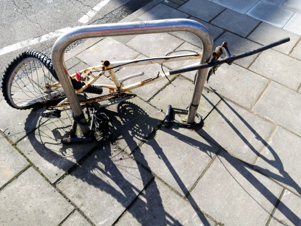 Damaged, abandoned cycle attached to Sheffield stand