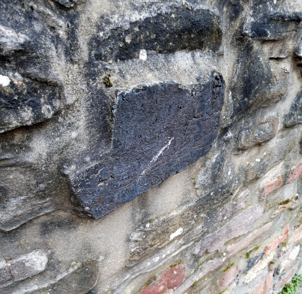 Slag block in stone wall, All Hallows Road, Easton