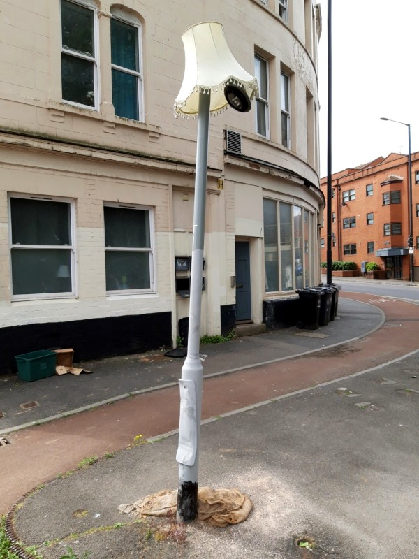 Illuminated signpost wearing a lampshade