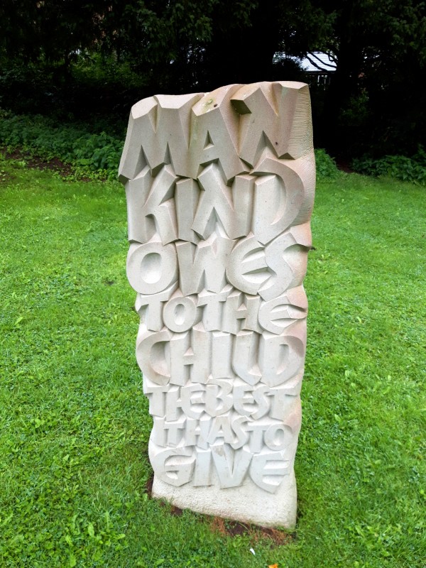 Sculpture in Cremorne Gardens in Ellesmere bearing the inscription Mankind owes to the child the very best it has to give