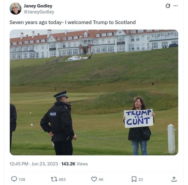 The late Janey Godley outside Turnberry holding a sign reading Trump is a cunt. 