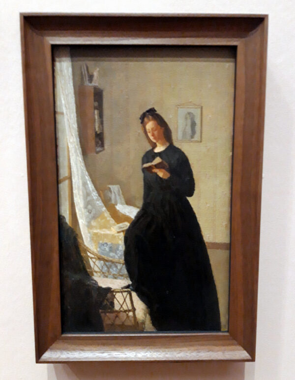 Girl reading a book by a window