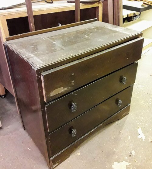 before shot - scuffed brown chest of drawers