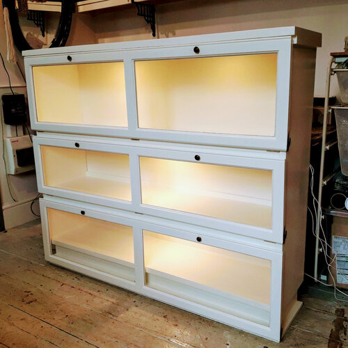 After - shelves fitted with reclaimed glass doors, painted, lighting added